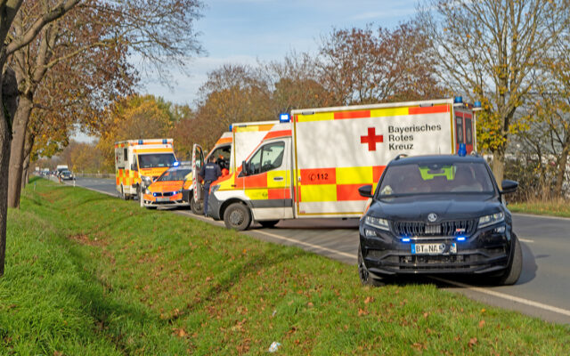 Einsatzfahrzeuge des Rettungsdienstes des Roten Kreuzes und der PKW des Notarztes am Einsatzort.